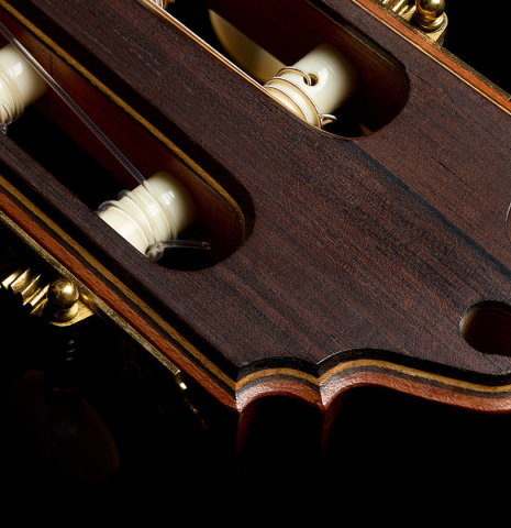 The carved headstock of a 1997 Paul Jacobson classical guitar made of cedar and CSA rosewood