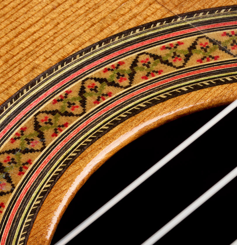 Closeup detail of the rosette and soundboard of a 1997 Paul Jacobson classical guitar made of cedar and CSA rosewood