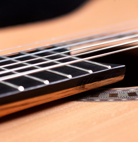 The elevated and floating fingerboard of a Wolfgang Jellinghaus "Signature CD/CD" classical guitar made of cedar and Granadillo