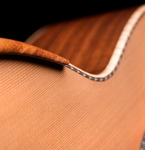 The armest on the top of a Wolfgang Jellinghaus "Signature CD/CD" classical guitar made of cedar and Granadillo