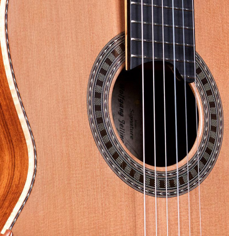 The top and elevated fingerboard of a Wolfgang Jellinghaus "Signature CD/CD" classical guitar made of cedar and Granadillo