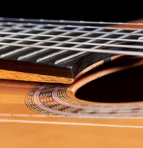 The elevated and floating fingerboard of a 2024 Wolfgang Jellinghaus "Signature CD/CD" classical guitar made of cedar and Granadillo