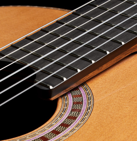The elevated fingerboard of a 2025 Wolfgang Jellinghaus "Signature CD/CD" classical guitar made of cedar and Granadillo