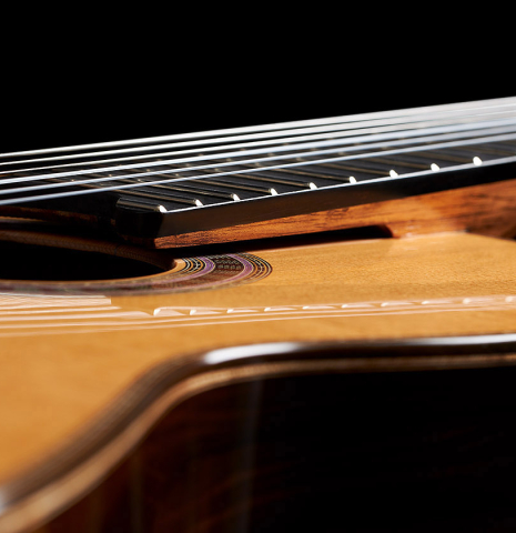 The elevated fingerboard of a 2024 Wolfgang Jellinghaus "Signature CD/CD" classical guitar made of cedar and ziricote