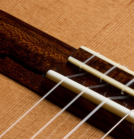 The bridge, tie-block and saddle of a 2026 Wolfgang Jellinghaus "Signature CD/CD" classical guitar made of cedar and ziricote