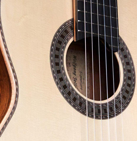The soundboard and rosette of a 2021 Wolfgang Jellinghaus "Signature SP/CD 640" SP/GR classical guitar.
