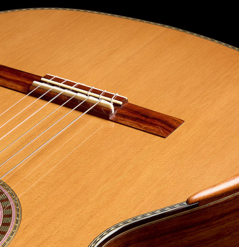 The bridge, tie-block, saddle and arm-rest of a 2025 Wolfgang Jellinghaus "Signature CD/SP" classical guitar made of cedar/spruce and granadillo