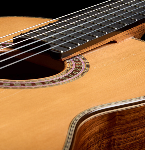 The elevated fingerboard and soundboard of a 2026 Wolfgang Jellinghaus "Signature CD/SP" classical guitar made of cedar/spruce and granadillo