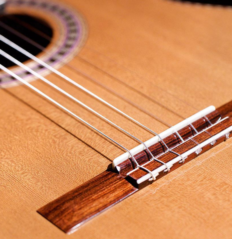 The bridge and soundboard of a 2020 Wolfgang Jellinghaus &quot;Alemana EF CD/CD&quot; CD/AR classical guitar made with double top cedar and African rosewood back and sides