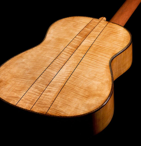The back of a 2023 Wolfgang Jellinghaus “Torres 43” classical guitar made with spruce and maple.