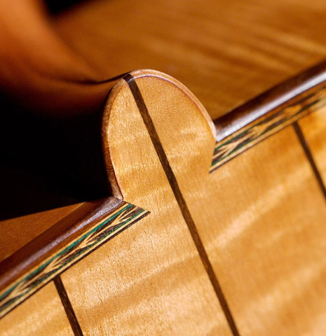 The heel of a 2023 Wolfgang Jellinghaus “Torres 43” classical guitar made with spruce and maple.
