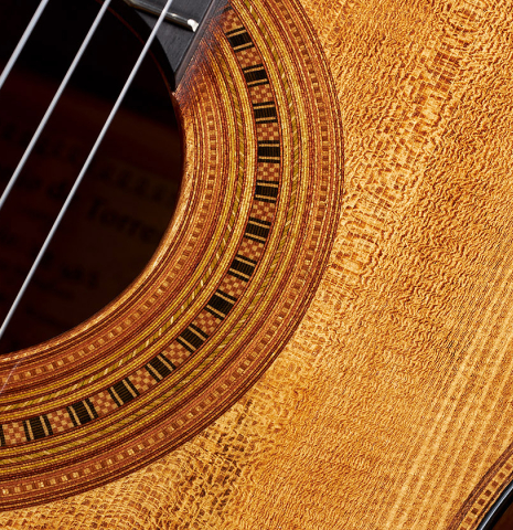 Closeup of the rosette of a Wolfgang Jellinghaus “Torres 43” classical guitar made with spruce and maple.