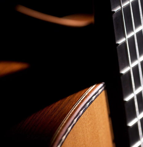 The side of the fingerboard and top purfling of a Wolfgang Jellinghaus "Alemana" 1a CD/CD" classical guitar made of cedar and African rosewood
