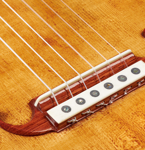 The bridge, tie-block and saddle of a Wolfgang Jellinghaus "La Romantica A" romantic guitar made with spruce and granadillo.