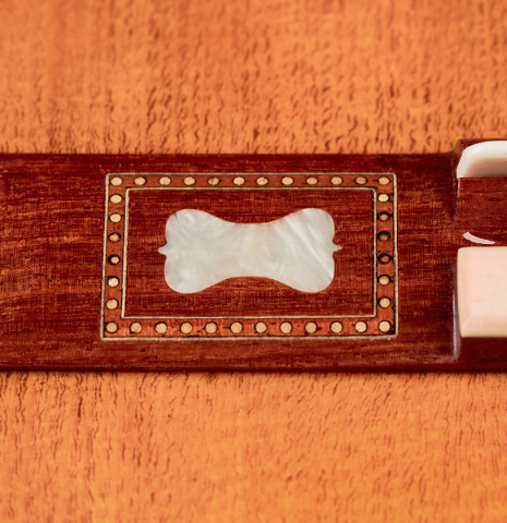 A close-up of the bridge of a Wolfgang Jellinghaus “Torres 43” classical guitar made with spruce and Indian rosewood