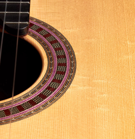The soundboard and rosette of a 2022 Wolfgang Jellinghaus &quot;Signature SP/SP 630&quot; double top guitar made of spruce and granadillo