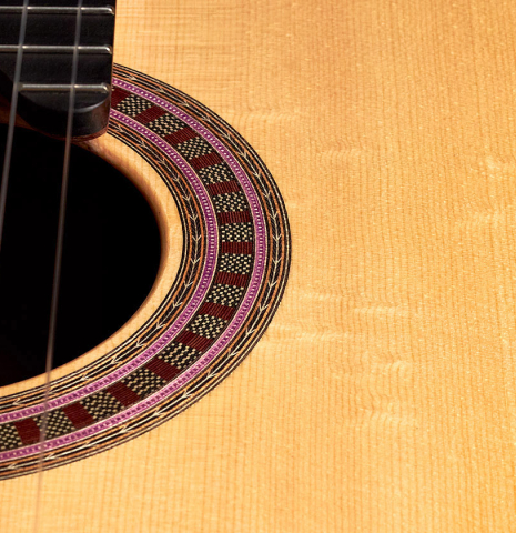 The soundboard and rosette of a 2022 Wolfgang Jellinghaus "Signature SP/SP 630" double top guitar made of spruce and granadillo