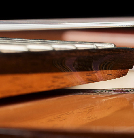 The elevated fingerboard of a 2025 Wolfgang Jellinghaus "Signature CD/CD 630" classical guitar made of cedar and granadillo