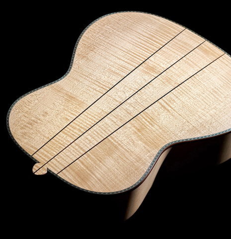 The back of a Wolfgang Jellinghaus “Torres 43 - clear” classical guitar made with spruce and maple.