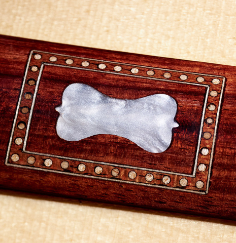 Detail of the bridge inlay of a Wolfgang Jellinghaus “Torres 43 - clear” classical guitar made with spruce and maple.