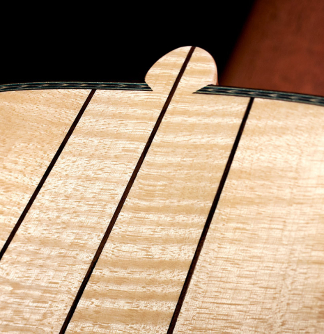 The back and heel of a Wolfgang Jellinghaus “Torres 43 - clear” classical guitar made with spruce and maple.