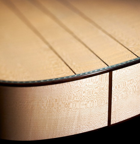 The lower bout of a Wolfgang Jellinghaus “Torres 43 - clear” classical guitar made with spruce and maple.