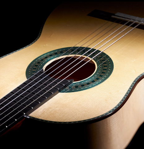 The front of a Wolfgang Jellinghaus “Torres 43 - clear” classical guitar made with spruce and maple.