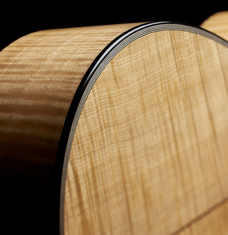 The back and sides of a Wolfgang Jellinghaus “Torres 43” classical guitar made of spruce and maple and clear finish