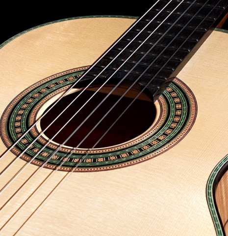 The soundboard and rosette of a Wolfgang Jellinghaus “Torres 49 - clear - ex Tarrega” classical guitar made of spruce and maple