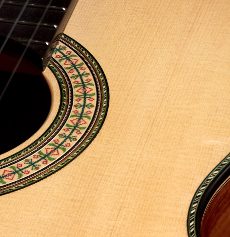 Closeup of the rosette of a Wolfgang Jellinghaus "1912 Ex-Segovia" classical guitar made of spruce and granadillo.