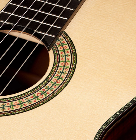 Closeup of the rosette of a 2023 Wolfgang Jellinghaus "1912 Ex-Segovia 640" classical guitar made of spruce and granadillo.