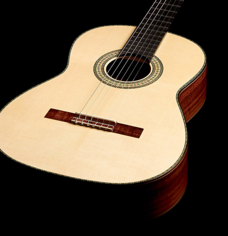 The soundboard and side of a 2023 Wolfgang Jellinghaus "1912 Ex-Segovia 640" classical guitar made of spruce and granadillo.