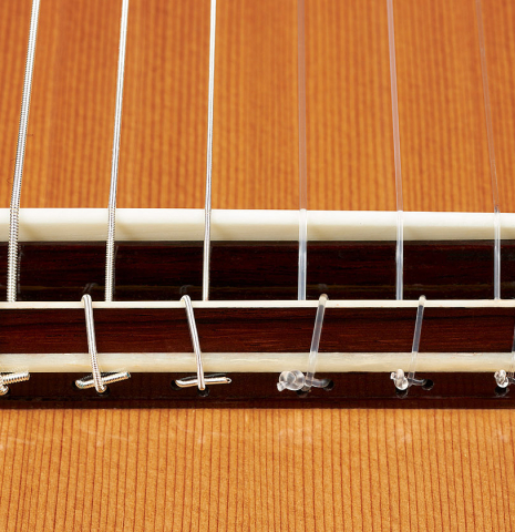 The bridge, tie-block and saddle of a Wolfgang Jellinghaus "Espanola A" classical guitar with cedar top and Indian rosewood back and sides