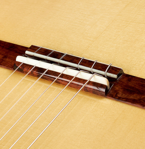 The bridge, tie-block and saddle of a Wolfgang Jellinghaus "Alemana" 1a SP/SP" classical guitar made of spruce and African rosewood