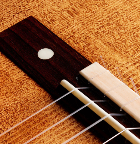 The bridge, tie-block and saddle of a 2023 Wolfgang Jellinghaus “Torres 114 - ex Tarrega” classical guitar made of spruce and cypress