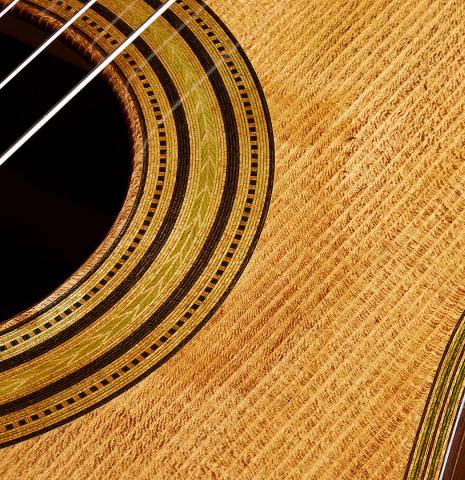 The top and rosette detail of a Wolfgang Jellinghaus “Torres FE 13” classical guitar with antiqued finish, made of spruce and Indian rosewood