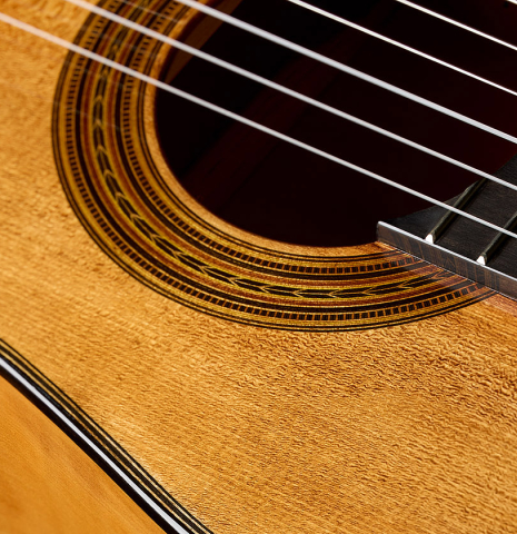 The soundboard and rosette of a Wolfgang Jellinghaus "Torres SE 02" classical guitar made with spruce and cypress
