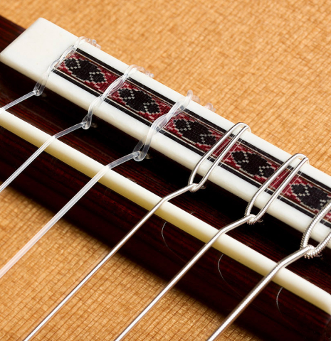 The bridge, tie-block and saddle of a 2026 Wolfgang Jellinghaus "Friederich" classical guitar made of cedar and Indian rosewood