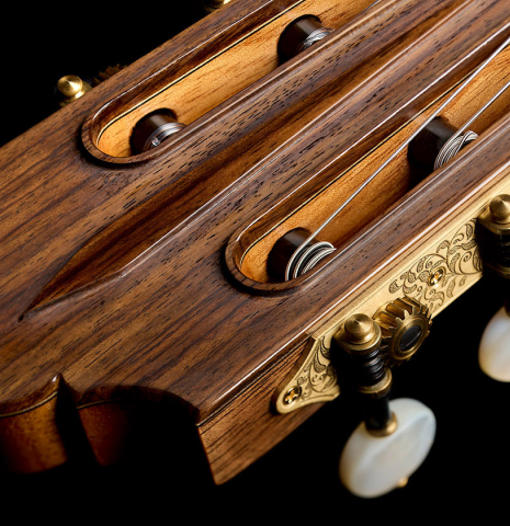 The carved headstock of a 2026 Wolfgang Jellinghaus "Friederich" classical guitar made of cedar and Indian rosewood