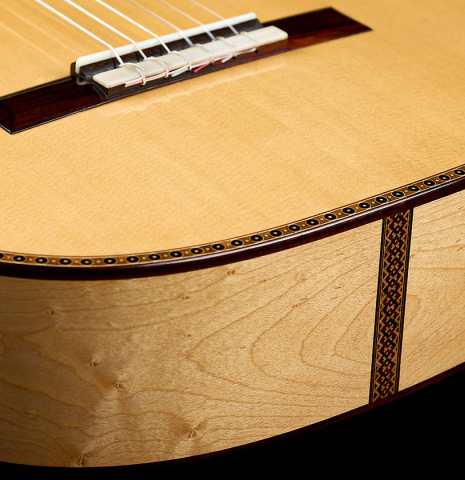 The sides and soundboard at the foot of a 2026 Federico Jiang "Arias" classical guitar made of spruce and maple