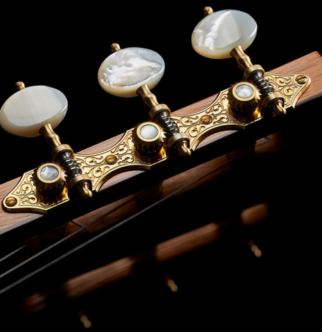 The headstock and tuning machines of a 2023 Francisco Jimenez classical guitar made of cedar and Indian rosewood