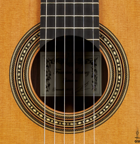 The rosette of a 2023 Francisco Jimenez classical guitar made of cedar and Indian rosewood