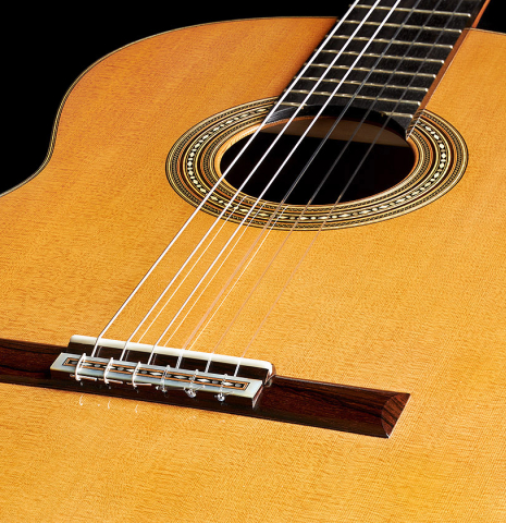 The soundboard of a 2023 Francisco Jimenez classical guitar made of cedar and Indian rosewood
