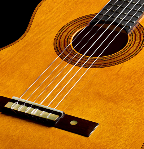 The soundboard of a 2025 Francisco Jimenez "Torres" classical guitar made of spruce and maple