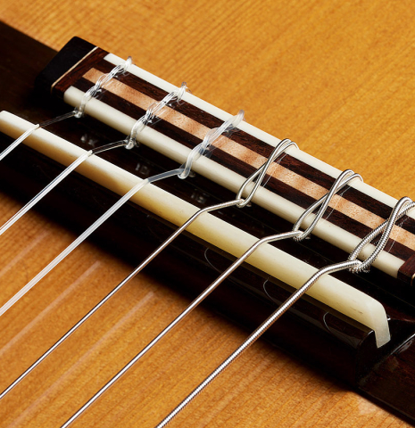 The bridge, tie-block and saddle of a 2025 So Kimishima “Stella” classical guitar made of cedar and Indian rosewood
