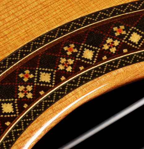 The top and rosette details of a 2025 So Kimishima “Stella” classical guitar made of cedar and Indian rosewood