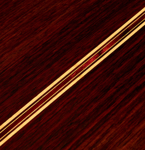 A close-up of the back of a 2022 So Kimishima “Stella” classical guitar made with spruce and Indian rosewood