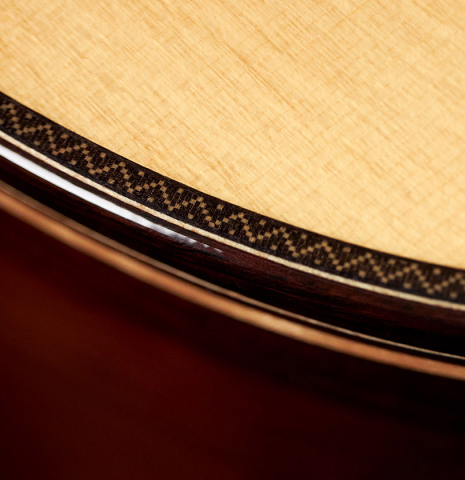 A close up of the top purfling and binding of a 2023 So Kimishima “Stella” classical guitar made with spruce and Indian rosewood