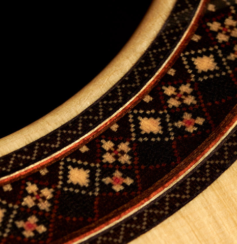 The rosette and soundboard of a 2023 So Kimishima “Stella” classical guitar made with spruce and Indian rosewood