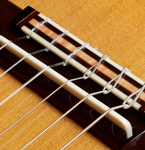 The bridge, tie-block and saddle of a 2024 So Kimishima “Stella” classical guitar (ex Shin-Ichi Fukuda) made of cedar and Indian rosewood